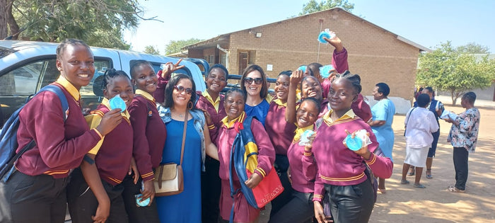 Happy students and pupils during a menstrual cup outreach where cups where donated.
