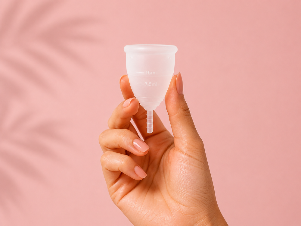 Female hand holding a Flo Angel menstrual cup